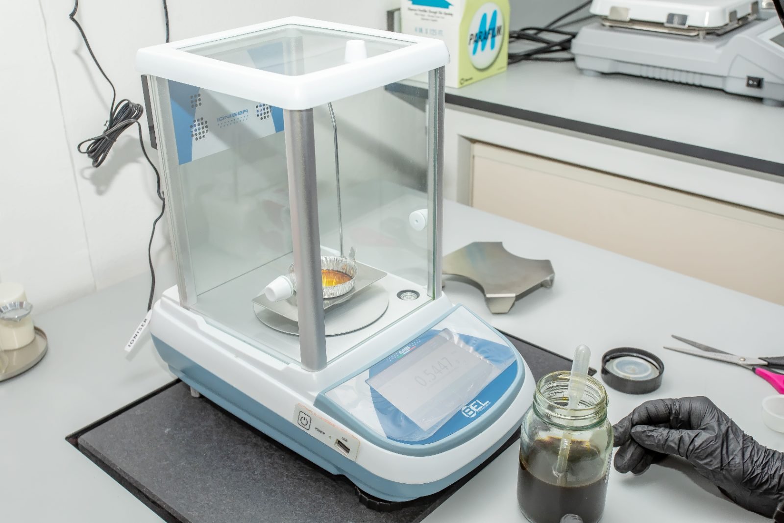 Analyst reading a graduated cylinder