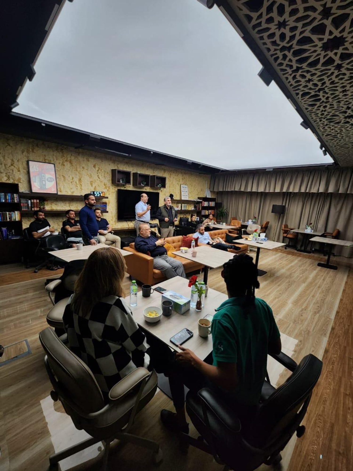 The team seated around the lounge tables listening to the session