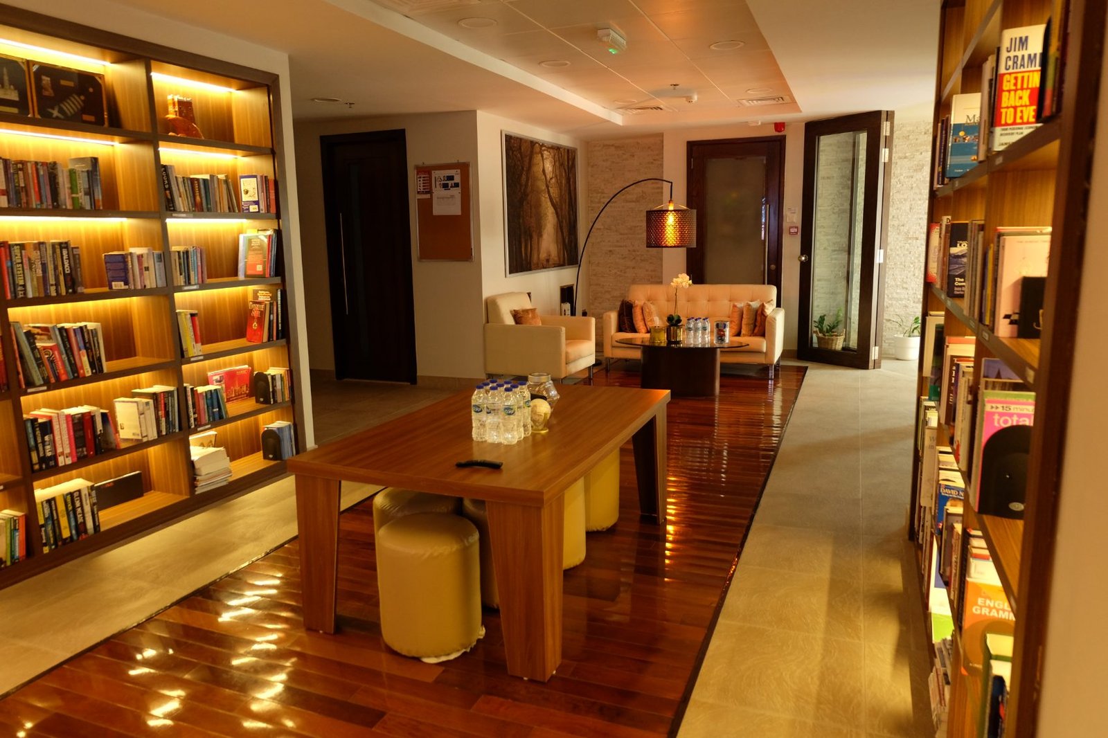 The library corridor at the Dubai office, shelves lit along both walls