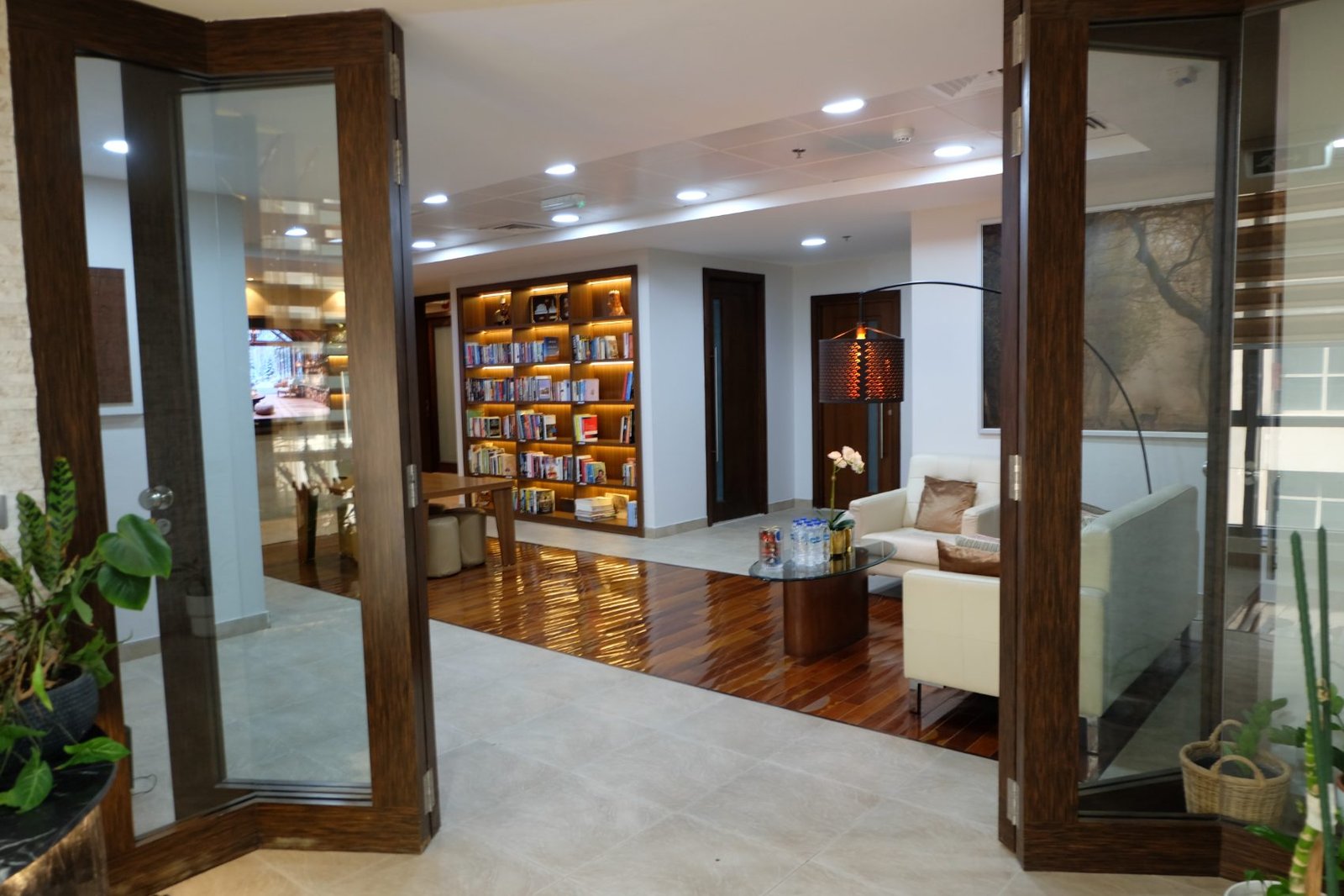 Shelves lit along the corridor, seating at the far end